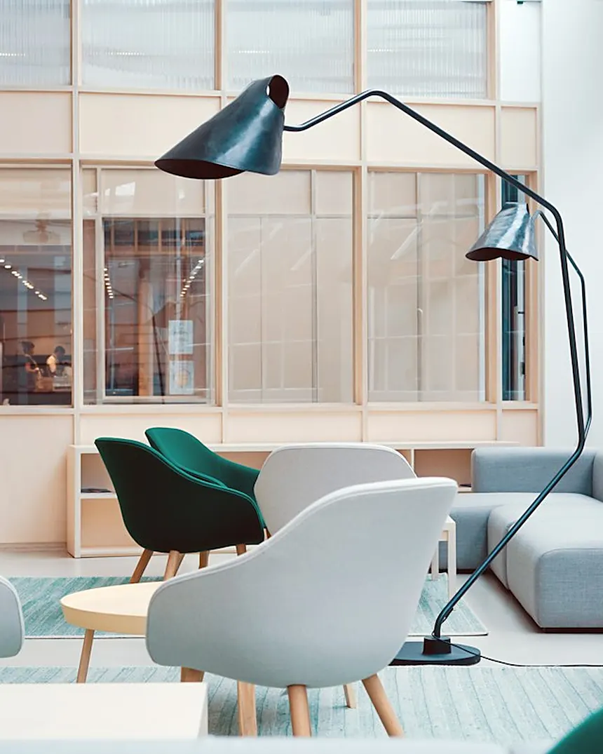 Bright office lounge with soft seating and meeting rooms