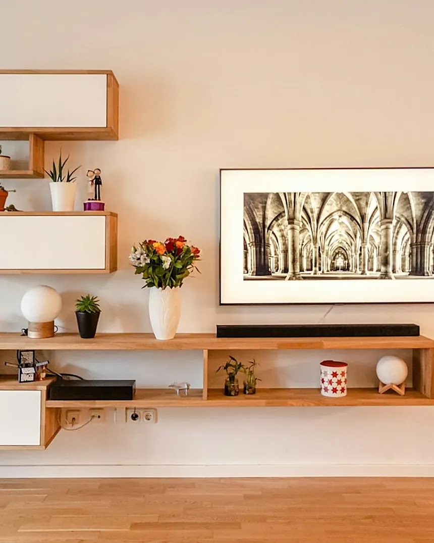 Retail shelving unit in oak with white wall-mounted frames